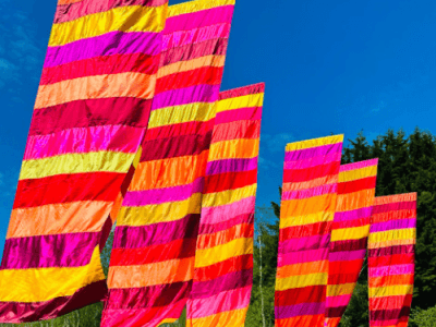 Striped festival flags against a blue sky