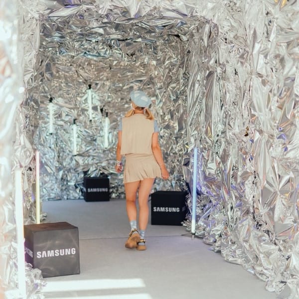 Visitor walking through a silver foil tunnel at a Samsung event