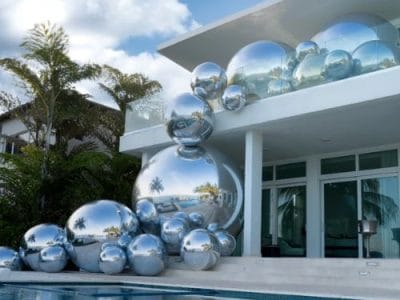 Silver mirror balls beside a swimming pool